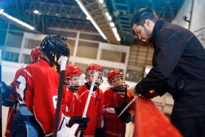 hockey coach helping players using online school registration