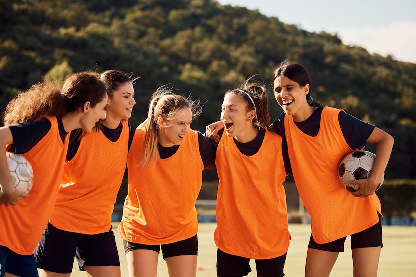 athletes in a circle on field