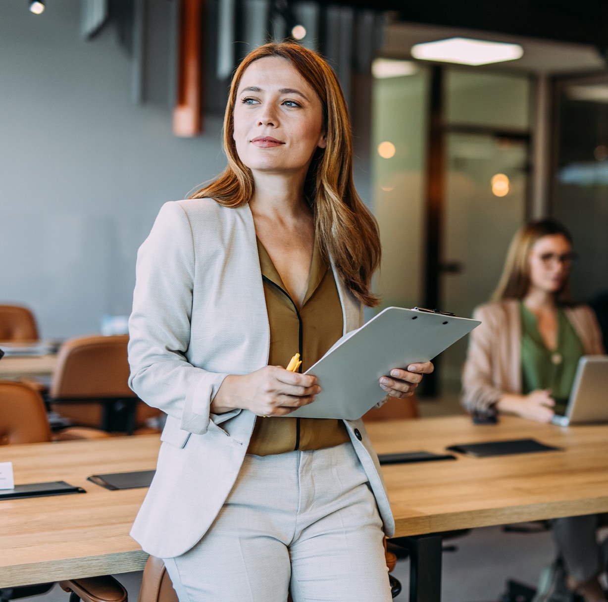 Woman in a business suit in a conference room.