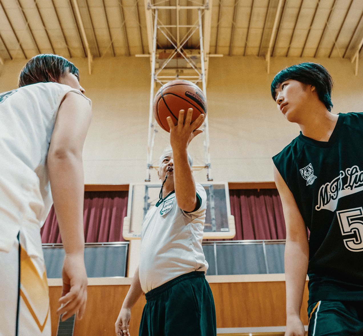 Referee starting a basketball game.