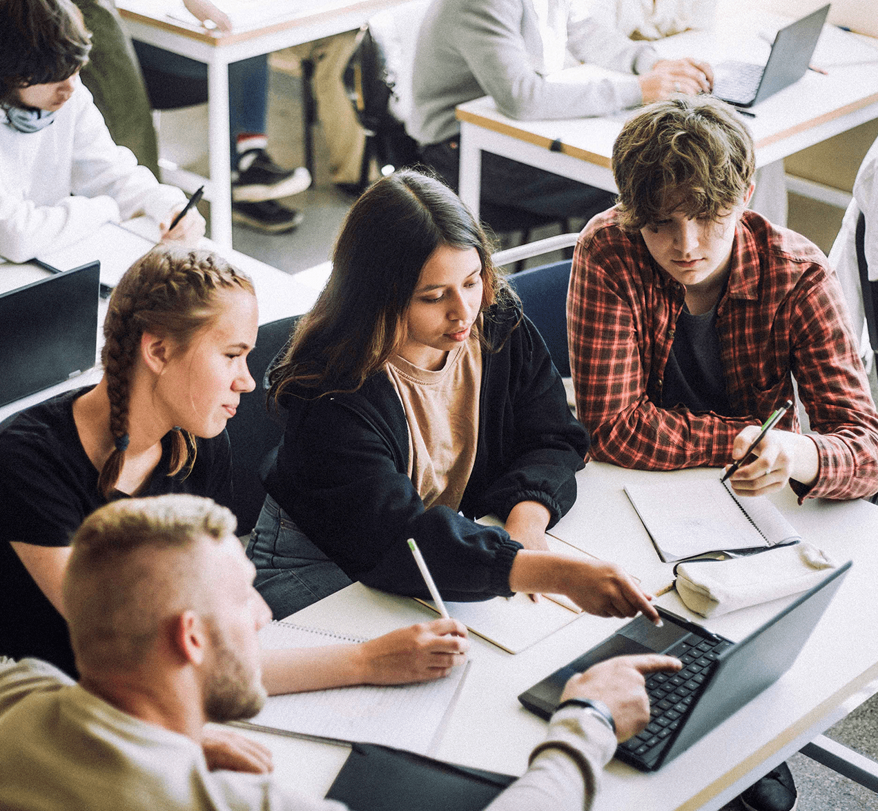 High school students working at a desk.