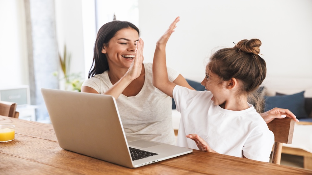 happy mom and child using online school registration