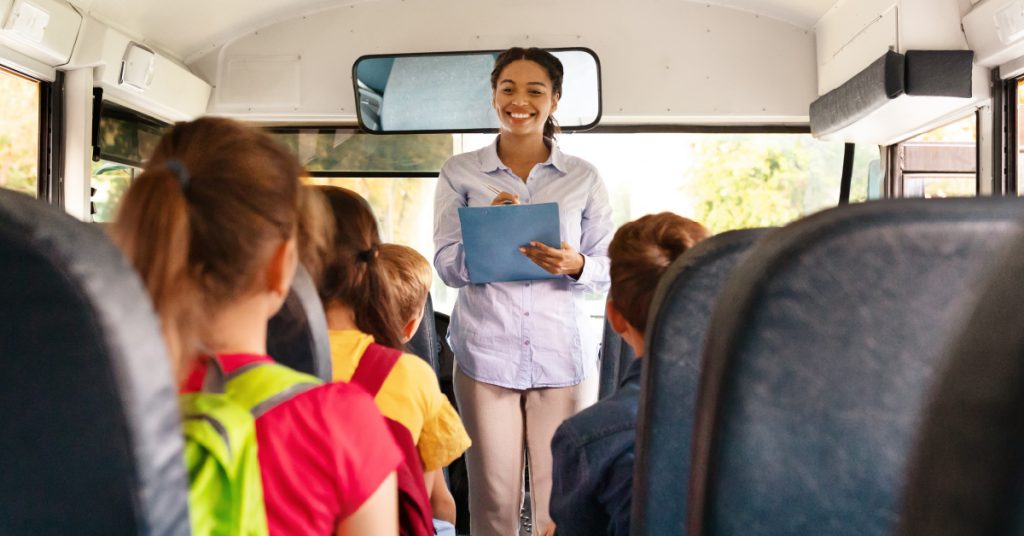 Female teacher taking head count on a field trip