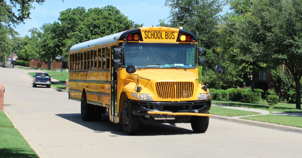 Yellow school bus on suburban street