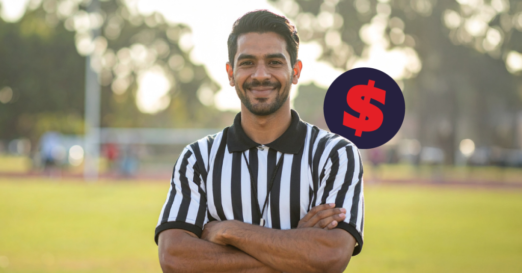 Referee standing confidently on field.