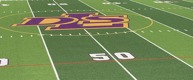 De La Salle Collegiate football field showing DLS logo, school that saved 20 hours monthly with Arbiter