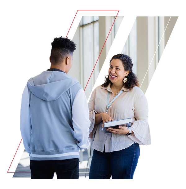 female teacher speaking with male student